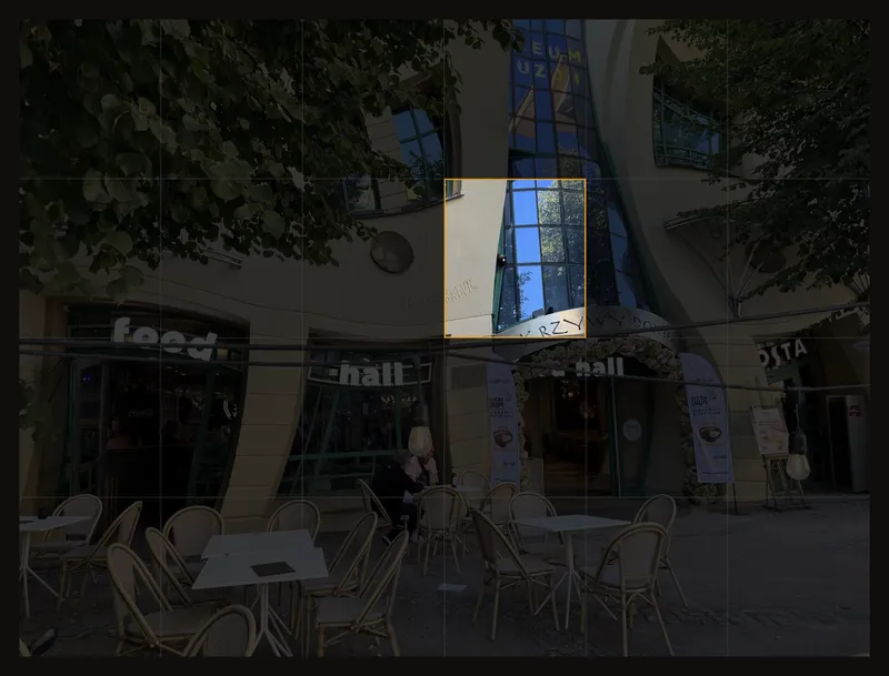 A curved building facade with one grid cell highlighted, isolating part of a sloping window frame